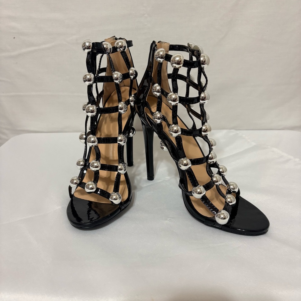 Yoki black patent leather strappy sandals.